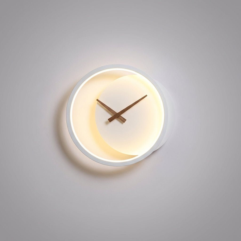 Modern minimalist LED wall clock featuring integrated warm white lighting, measuring 27x25cm, perfect for stylish home decor. 0